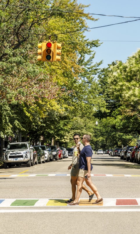 couple walking down rainbow sidewalk in saugatuck